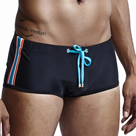 a hot gay man in black Bold Stripe Swim Trunks - pridevoyageshop.com - gay men’s underwear and swimwear