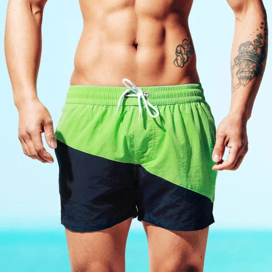 a hot guy in green Tidal Charm Two Toned Board Shorts - pridevoyageshop.com - gay men’s underwear and swimwear