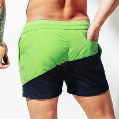 a hot guy in green Tidal Charm Two Toned Board Shorts - pridevoyageshop.com - gay men’s underwear and swimwear