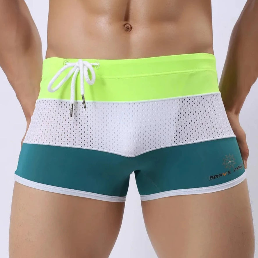 a hot gay man in Green + White + Neon Men's Tricolor Mesh Swim Trunks - pridevoyageshop.com - gay men’s underwear and swimwear