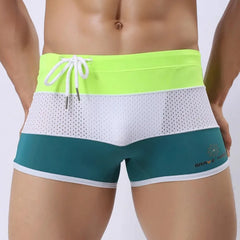 a hot gay man in Green + White + Neon Men's Tricolor Mesh Swim Trunks - pridevoyageshop.com - gay men’s underwear and swimwear