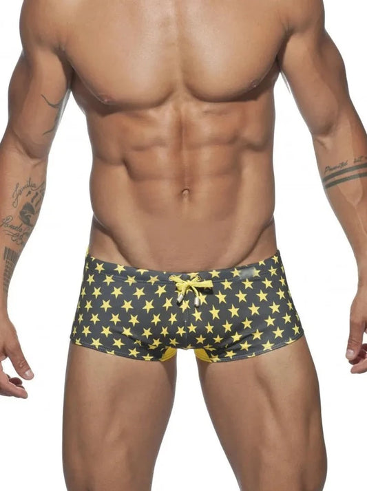 a hot gay man in black Stars Tight Square Cut Swim Trunks - pridevoyageshop.com - gay men’s underwear and swimwear