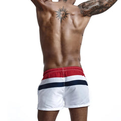 a hot gay man in Siren's Stripe Swim Trunks - pridevoyageshop.com - gay men’s underwear and swimwear