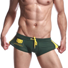 a sexy gay man in green Men's Athletic Square Cut Swim Trunks - pridevoyageshop.com - gay men’s underwear and swimwear