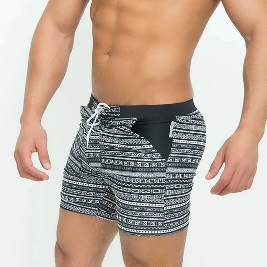 a hot man in Aztec Tribal Tight Board Shorts - pridevoyageshop.com - gay men’s underwear and swimwear