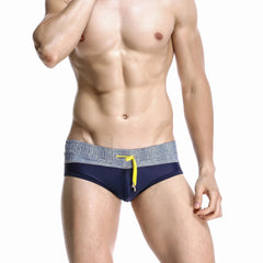 a hot gay man in navy blue Men's Wide Gray Band Swim Briefs - pridevoyageshop.com - gay men’s underwear and swimwear