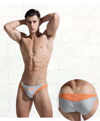 a sexy gay man in gray DESMIIT Men's D-Surf Swim Briefs - pridevoyageshop.com - gay men’s underwear and swimwear