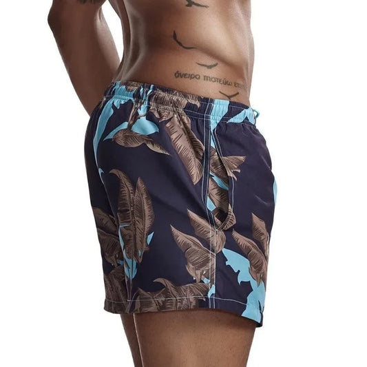 a hot gay man in Banana Trees Board Shorts - pridevoyageshop.com - gay men’s underwear and swimwear