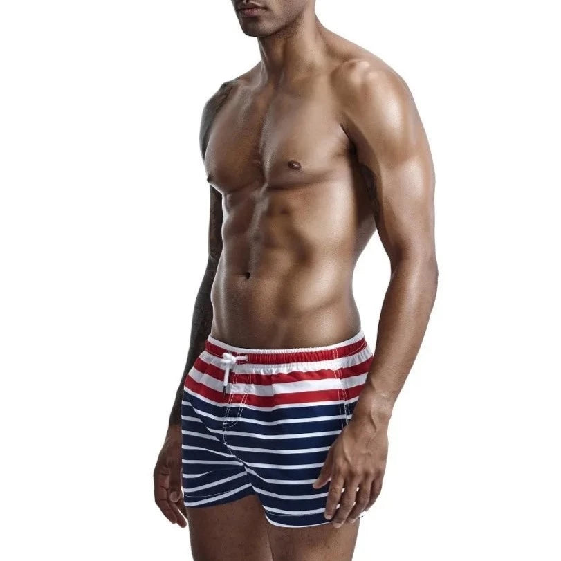 a hot gay man in Men's Sailor Striped Board Shorts - pridevoyageshop.com - gay men’s underwear and swimwear