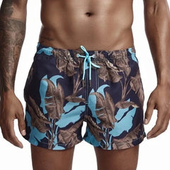 a hot gay man in Banana Trees Board Shorts - pridevoyageshop.com - gay men’s underwear and swimwear