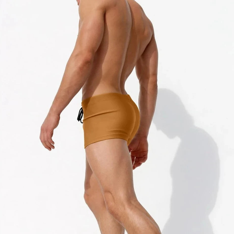 a hot gay man in brown Solid Color Bowtie Swim Trunks - pridevoyageshop.com - gay men’s underwear and swimwear