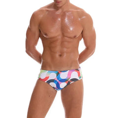 a hot gay man in Men's S-Wave Swim Briefs - pridevoyageshop.com - gay men’s underwear and swimwear