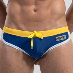 a hot gay man in Dark Blue DESMIIT Retro Swim Briefs - pridevoyageshop.com - gay men’s underwear and swimwear