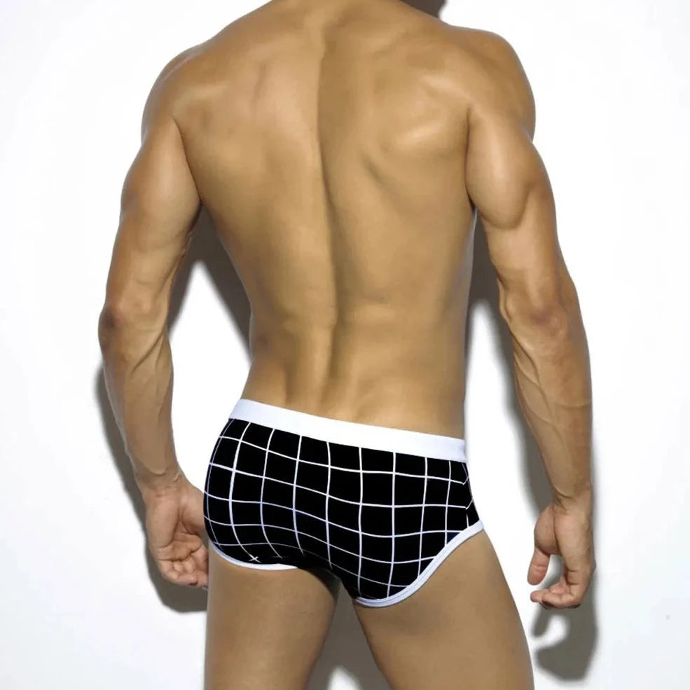 a hot gay man in Men's Black Grid Swim Briefs - pridevoyageshop.com - gay men’s underwear and swimwear