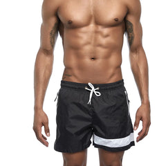 a hot gay man in black Reflex Racer Board Shorts - pridevoyageshop.com - gay men’s underwear and swimwear