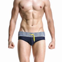 a hot gay man in navy blue Men's Wide Gray Band Swim Briefs - pridevoyageshop.com - gay men’s underwear and swimwear