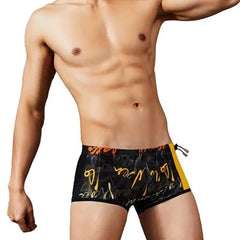 a hot gay man in Alphabet Graffiti Print Swim Trunks - pridevoyageshop.com - gay men’s underwear and swimwear