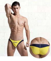a sexy gay man in yellow DESMIIT Men's D-Surf Swim Briefs - pridevoyageshop.com - gay men’s underwear and swimwear