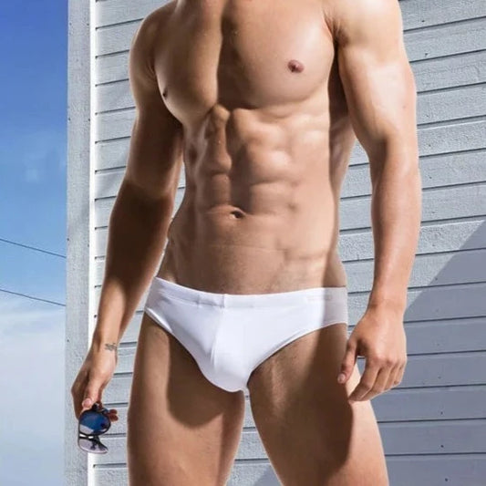 a sexy gay man in white DESMIIT Solid Color Swim Briefs - pridevoyageshop.com - gay men’s underwear and swimwear