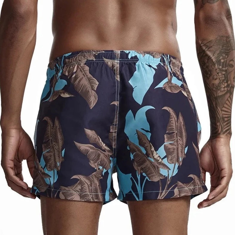 a hot gay man in Banana Trees Board Shorts - pridevoyageshop.com - gay men’s underwear and swimwear