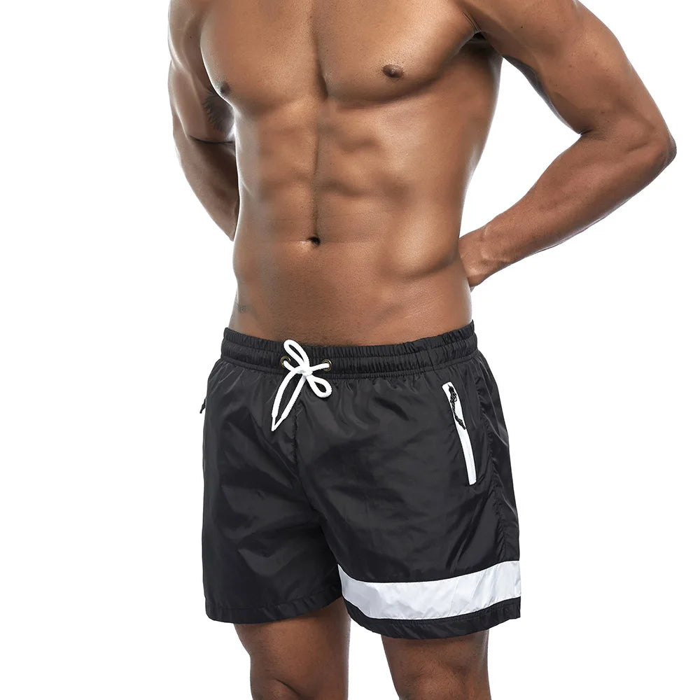 a hot gay man in black Reflex Racer Board Shorts - pridevoyageshop.com - gay men’s underwear and swimwear