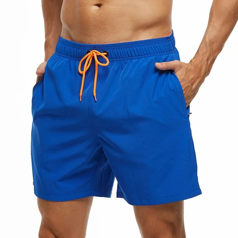 a hot gay man in blue Solid Color Pocketed Board Shorts - pridevoyageshop.com - gay men’s underwear and swimwear