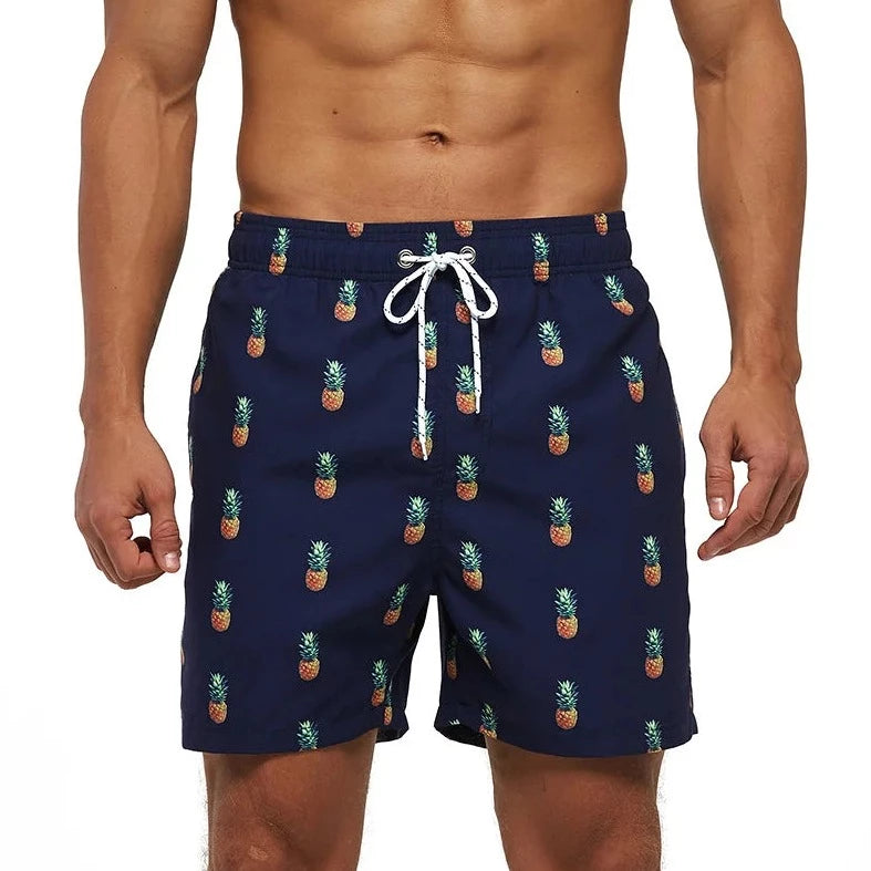 a hot gay man in Navy Pineapple Board Shorts - pridevoyageshop.com - gay men’s underwear and swimwear
