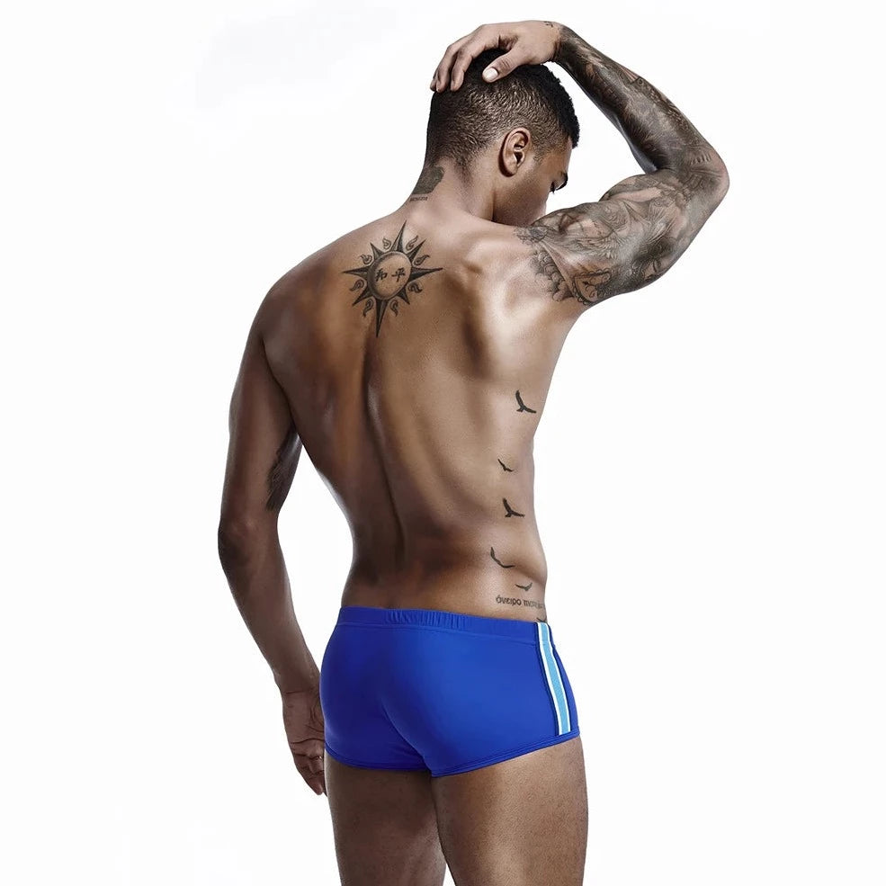 a hot gay man in blue Bold Stripe Swim Trunks - pridevoyageshop.com - gay men’s underwear and swimwear
