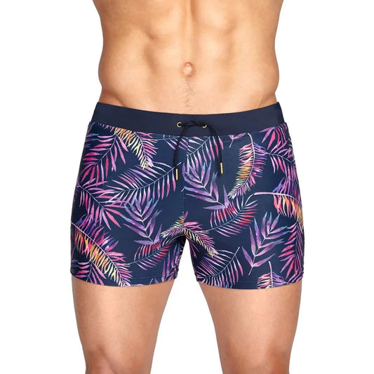 a hot gay man in Neon Palms Swim Trunks - pridevoyageshop.com - gay men’s underwear and swimwear