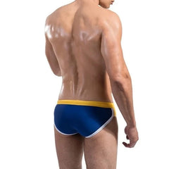 a hot gay man in Dark Blue DESMIIT Retro Swim Briefs - pridevoyageshop.com - gay men’s underwear and swimwear