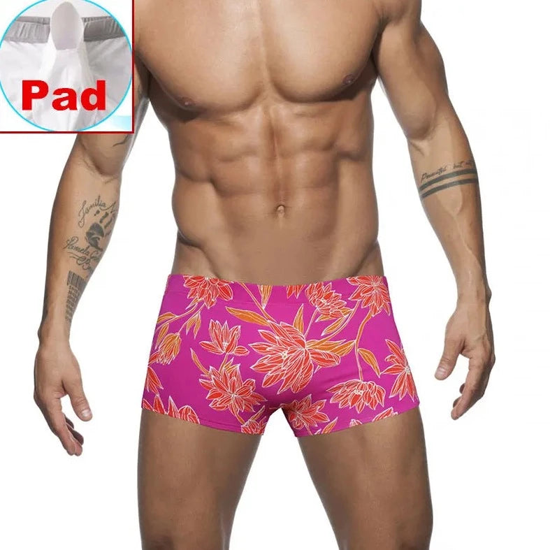 a hot gay man in pink Bold Neon Forest Swim Trunks - pridevoyageshop.com - gay men’s underwear and swimwear