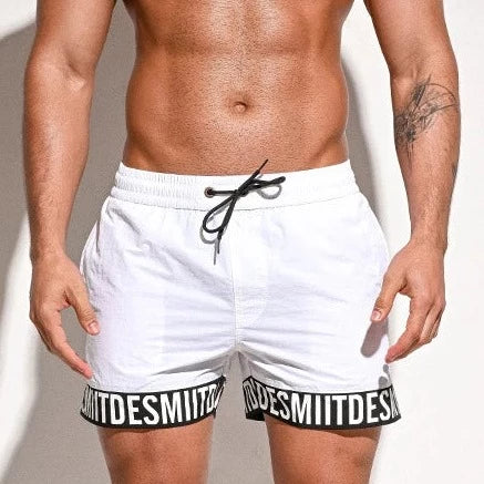 a hot man in white Desmiit Scripted Tide Board Shorts - pridevoyageshop.com - gay men’s underwear and swimwear