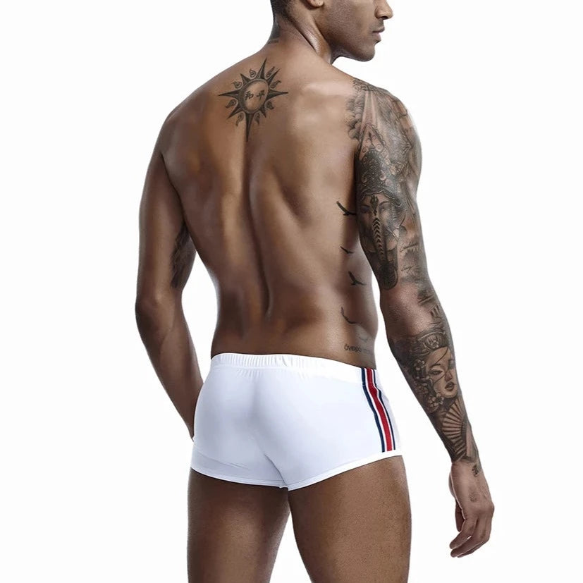 a hot gay man in white Bold Stripe Swim Trunks - pridevoyageshop.com - gay men’s underwear and swimwear