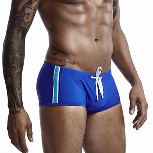 a hot gay man in blue Bold Stripe Swim Trunks - pridevoyageshop.com - gay men’s underwear and swimwear