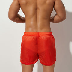 sexy gay man in orange Gay Beachwear | Men's Transparent Board Shorts with Pockets - pridevoyageshop.com - gay men’s underwear and swimwear