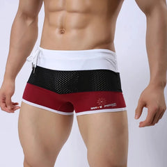 a hot gay man in Red + Black + White Men's Tricolor Mesh Swim Trunks - pridevoyageshop.com - gay men’s underwear and swimwear