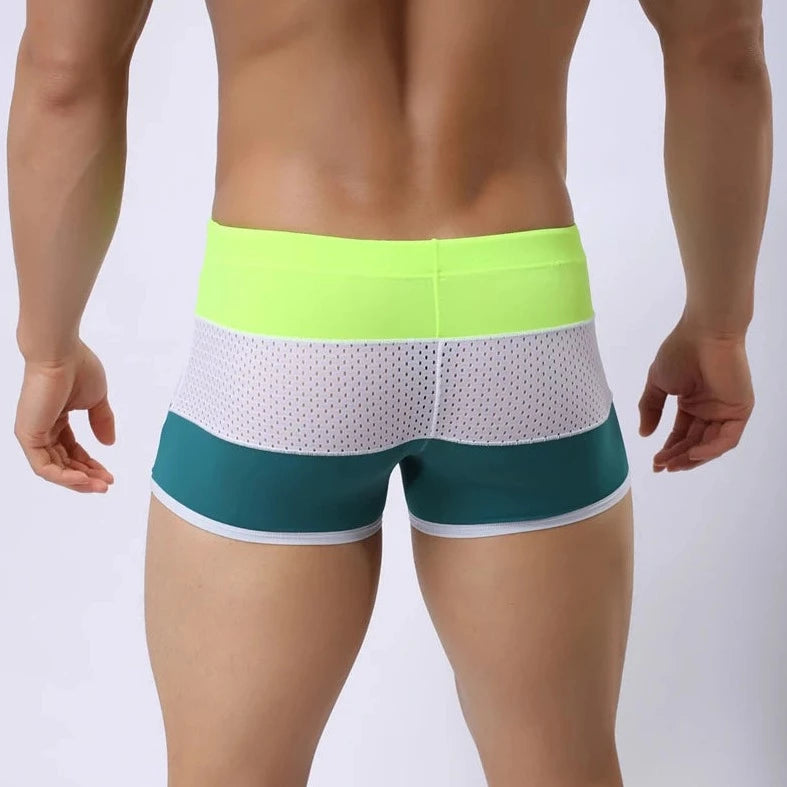 a hot gay man in Green + White + Neon Men's Tricolor Mesh Swim Trunks - pridevoyageshop.com - gay men’s underwear and swimwear