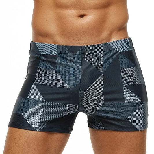 a hot gay man in Men's Gray Geo Swim Trunks - pridevoyageshop.com - gay men’s underwear and swimwear