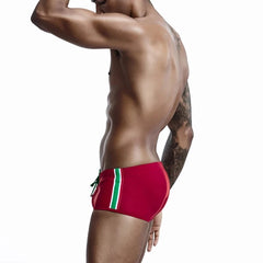 a hot gay man in red Bold Stripe Swim Trunks - pridevoyageshop.com - gay men’s underwear and swimwear