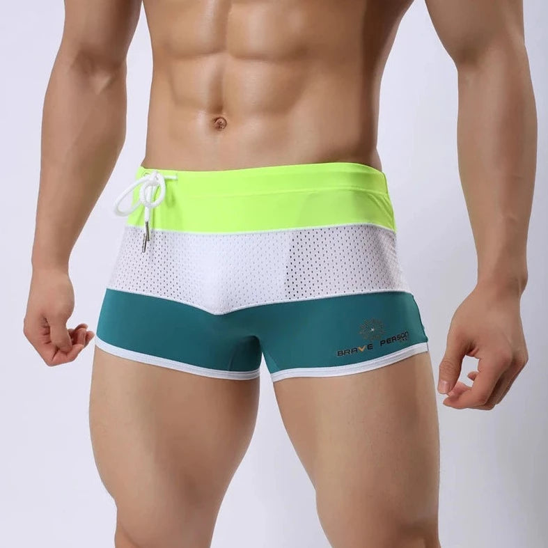 a hot gay man in Green + White + Neon Men's Tricolor Mesh Swim Trunks - pridevoyageshop.com - gay men’s underwear and swimwear