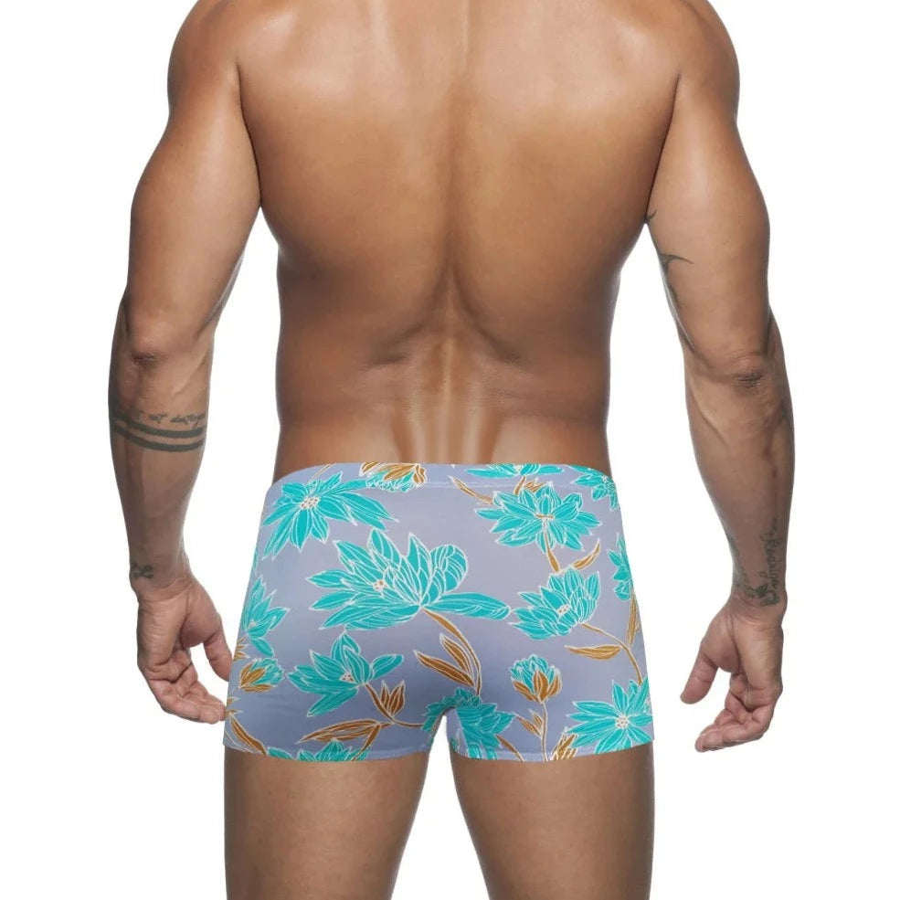 a hot gay man in blue Bold Neon Forest Swim Trunks - pridevoyageshop.com - gay men’s underwear and swimwear