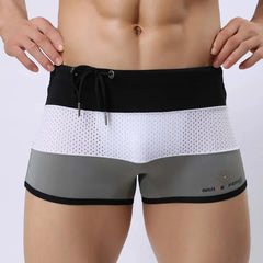 a hot gay man in Grey + White + Black Men's Tricolor Mesh Swim Trunks - pridevoyageshop.com - gay men’s underwear and swimwear