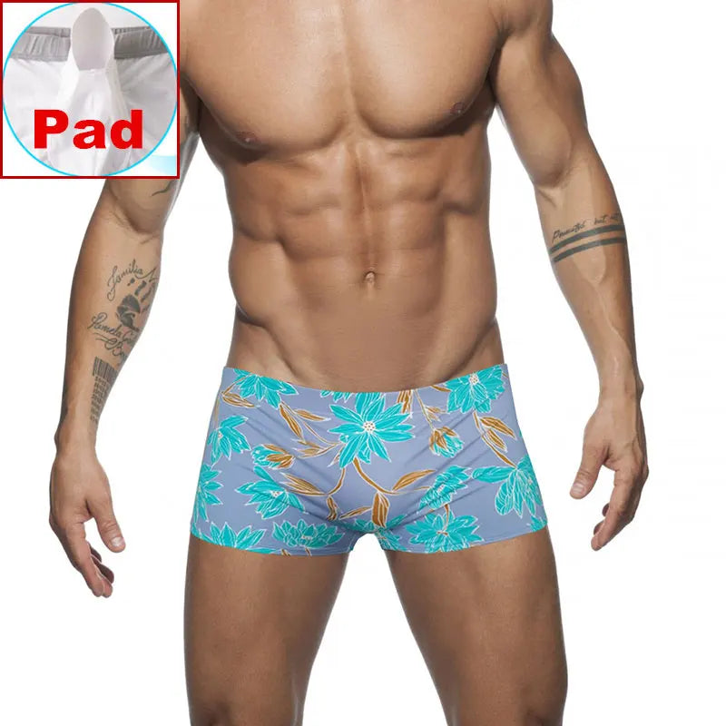 a hot gay man in blue Bold Neon Forest Swim Trunks - pridevoyageshop.com - gay men’s underwear and swimwear