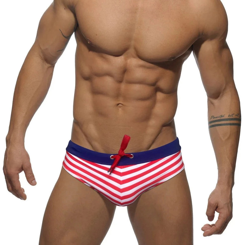 a hot gay man in red Sailor‘s Striped Bowtie Swim Briefs - pridevoyageshop.com - gay men’s underwear and swimwear