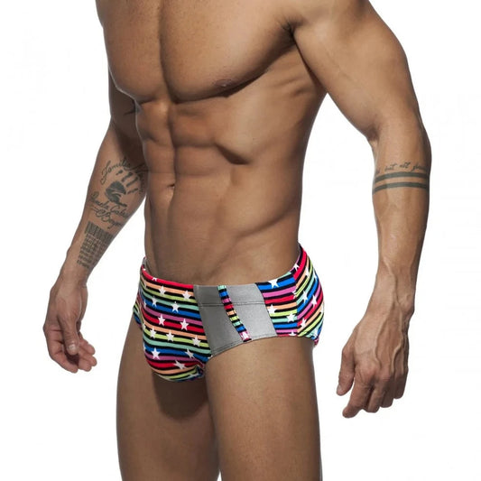 a hot gay man in Men's Rainbow Star Striped Swim Briefs - pridevoyageshop.com - gay men’s underwear and swimwear
