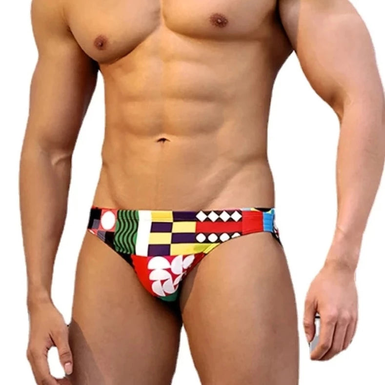 a sexy gay man in Colorful Patchwork Swim Briefs - pridevoyageshop.com - gay men’s underwear and swimwear