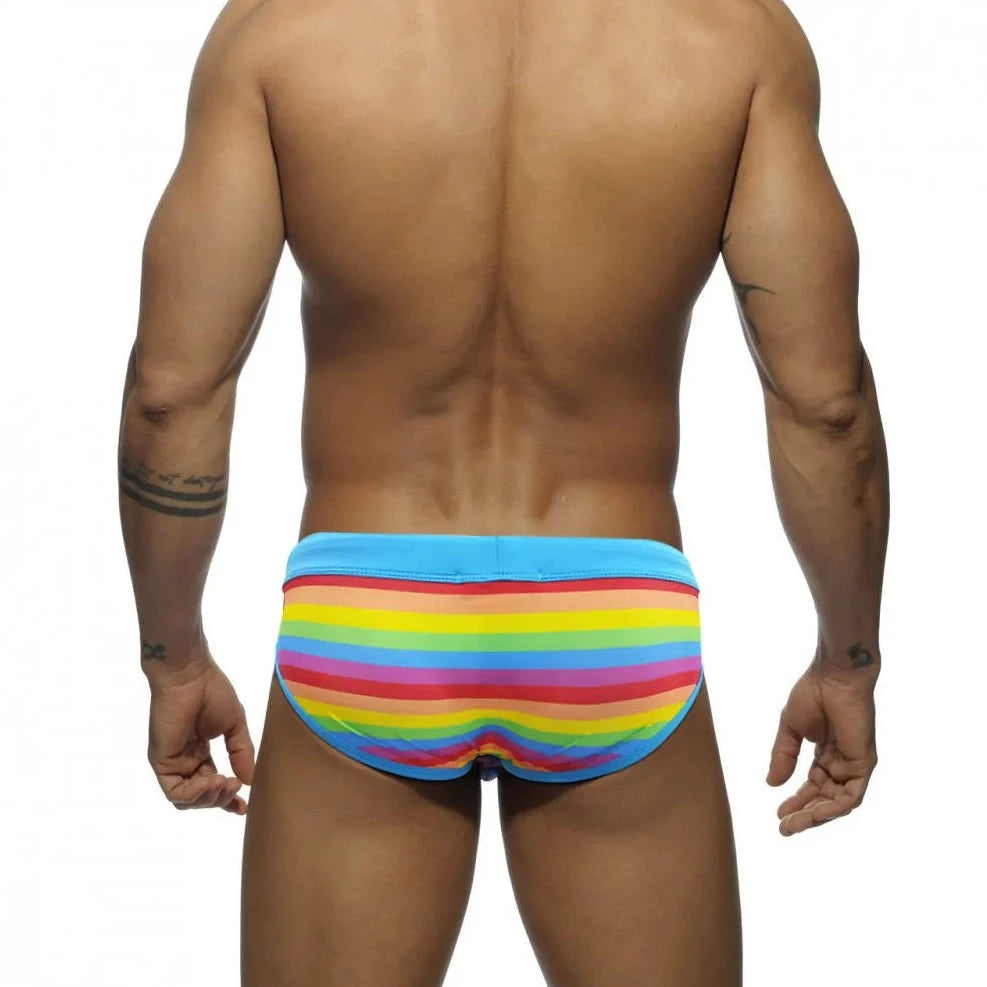 a sexy gay man in Drawstring Rainbow Swim Briefs - pridevoyageshop.com - gay men’s underwear and swimwear