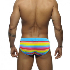 a sexy gay man in Drawstring Rainbow Swim Briefs - pridevoyageshop.com - gay men’s underwear and swimwear