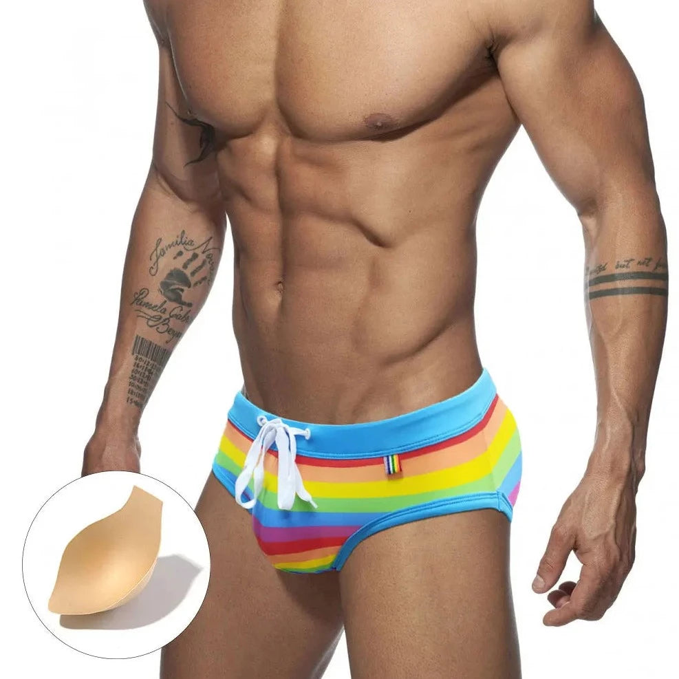 a sexy gay man in Drawstring Rainbow Swim Briefs - pridevoyageshop.com - gay men’s underwear and swimwear