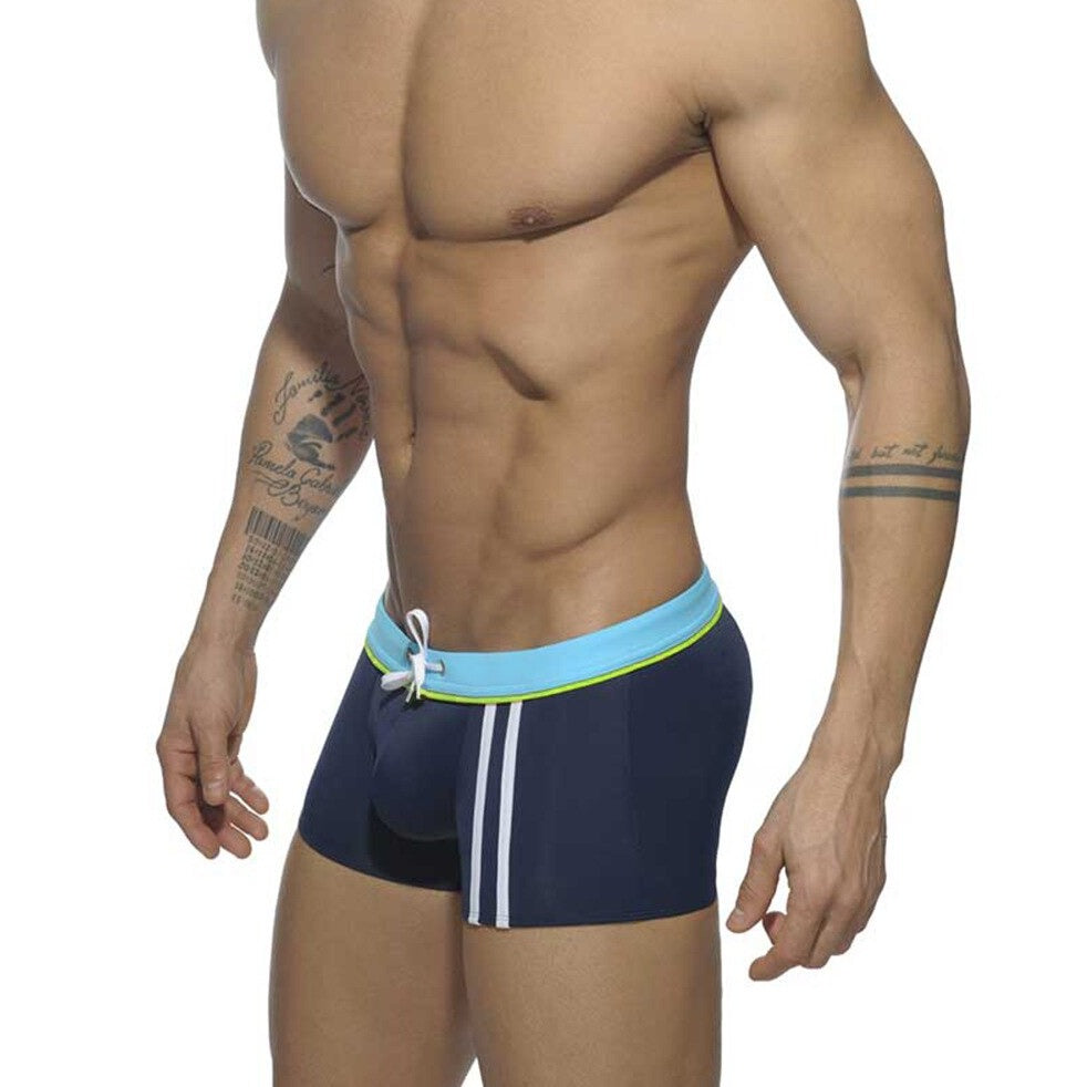 hot gay man in blue Gay Swimwear | Men's Square Cut Racing Stripe Swim Trunks - pridevoyageshop.com - gay men’s underwear and swimwear